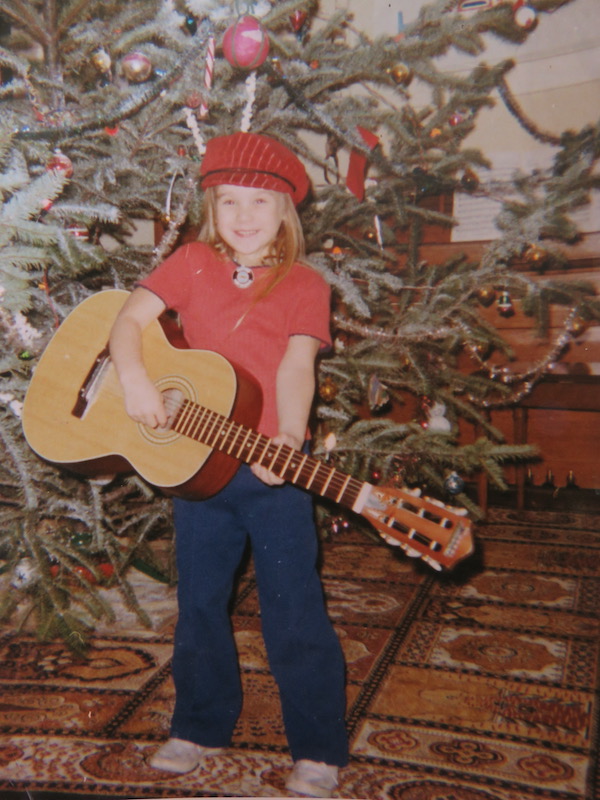 Lis Nagy with a guitar around age 5